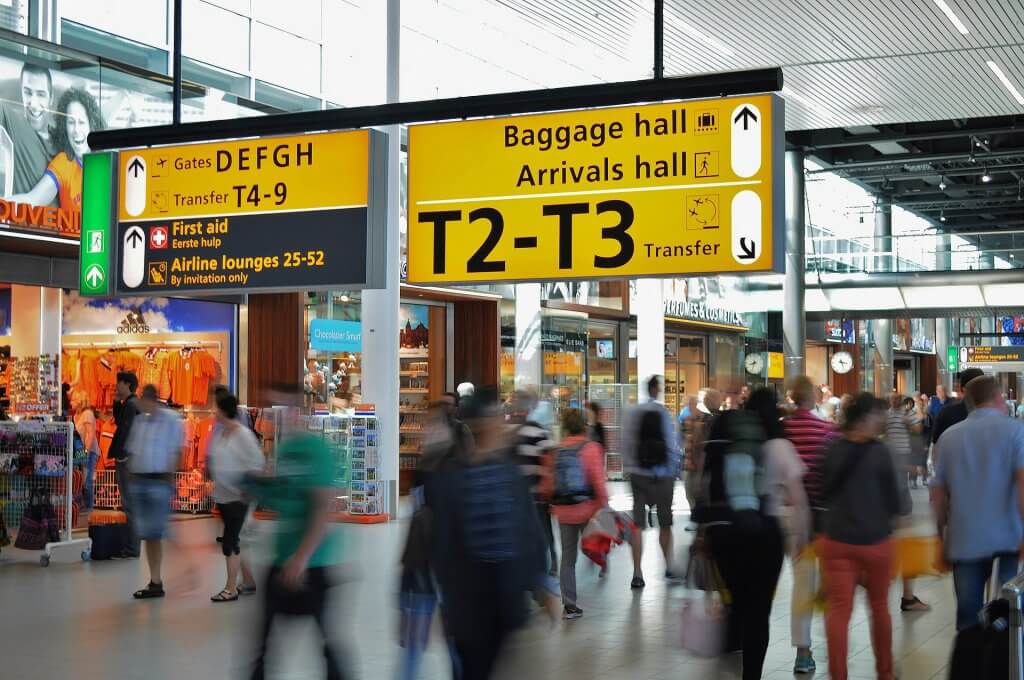 Long exposure of people walking through an airport terminal