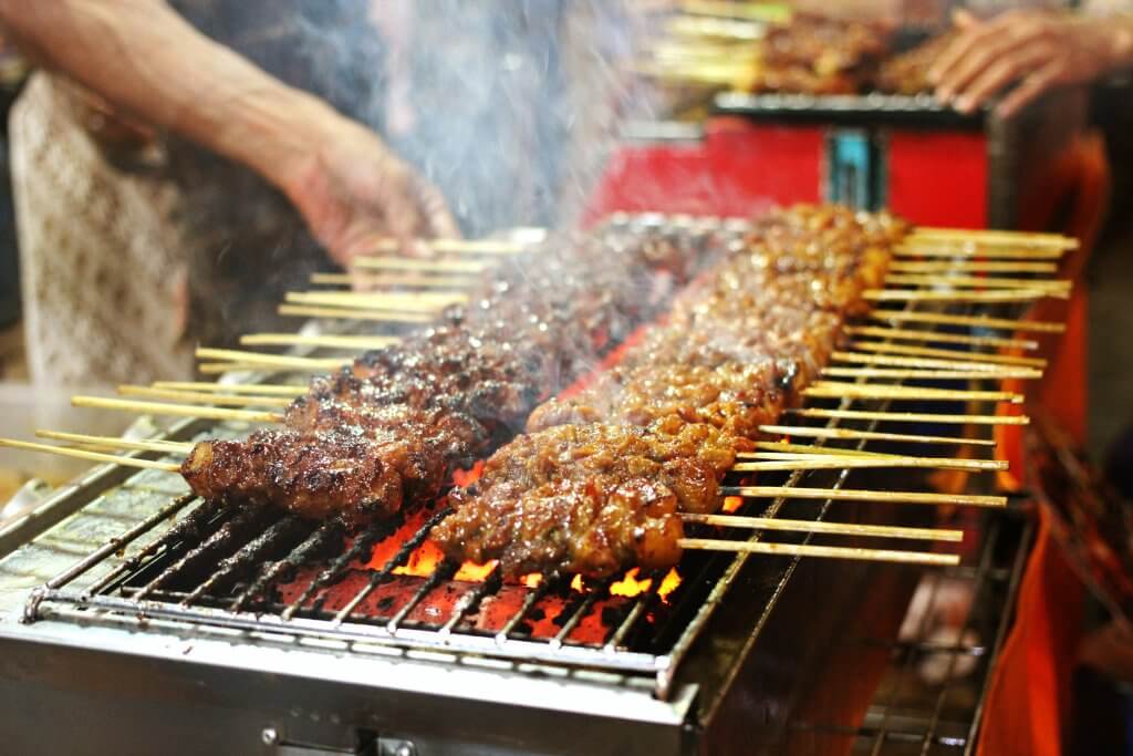 meat on a stick over a charcoal grill