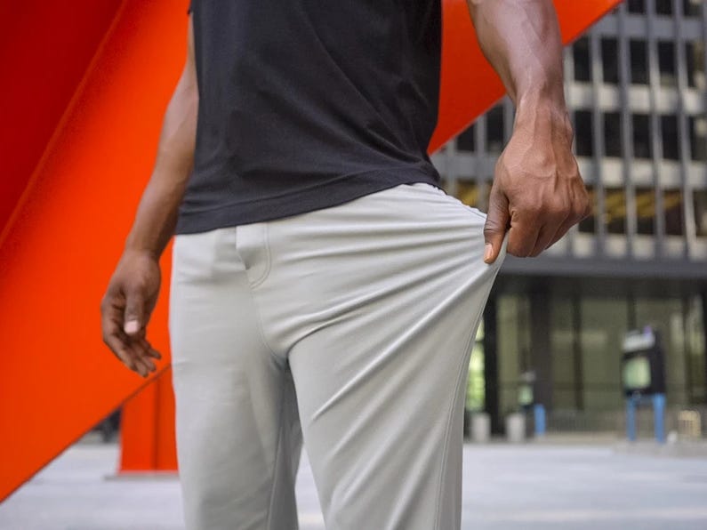 chest-down photo of man stretching his travel pants