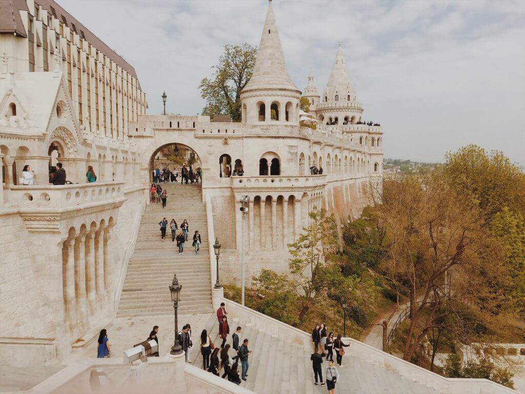 People walking down castle steps