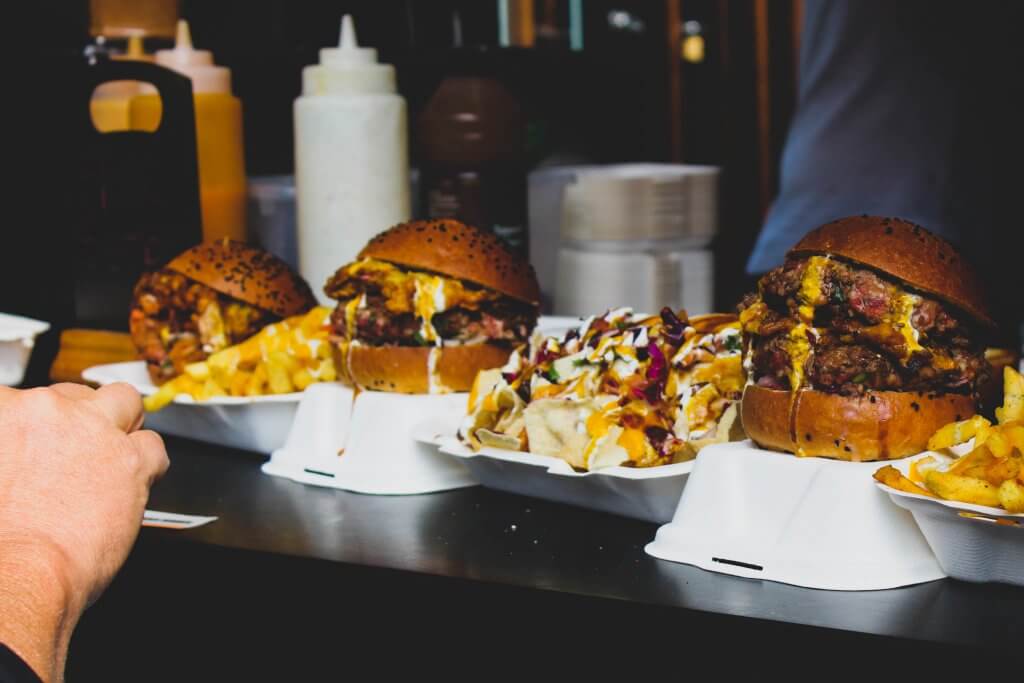 burgers and fries on a market counter