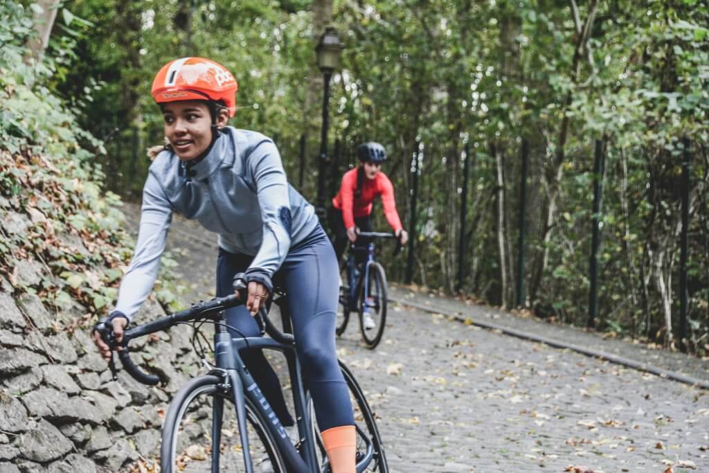 women on bicycles round a corner