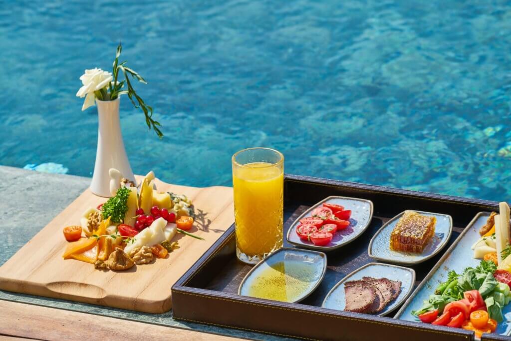 Colorful platter of brunch foods next to a hotel pool