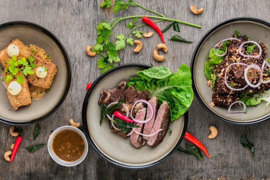 bowls of steak and fish