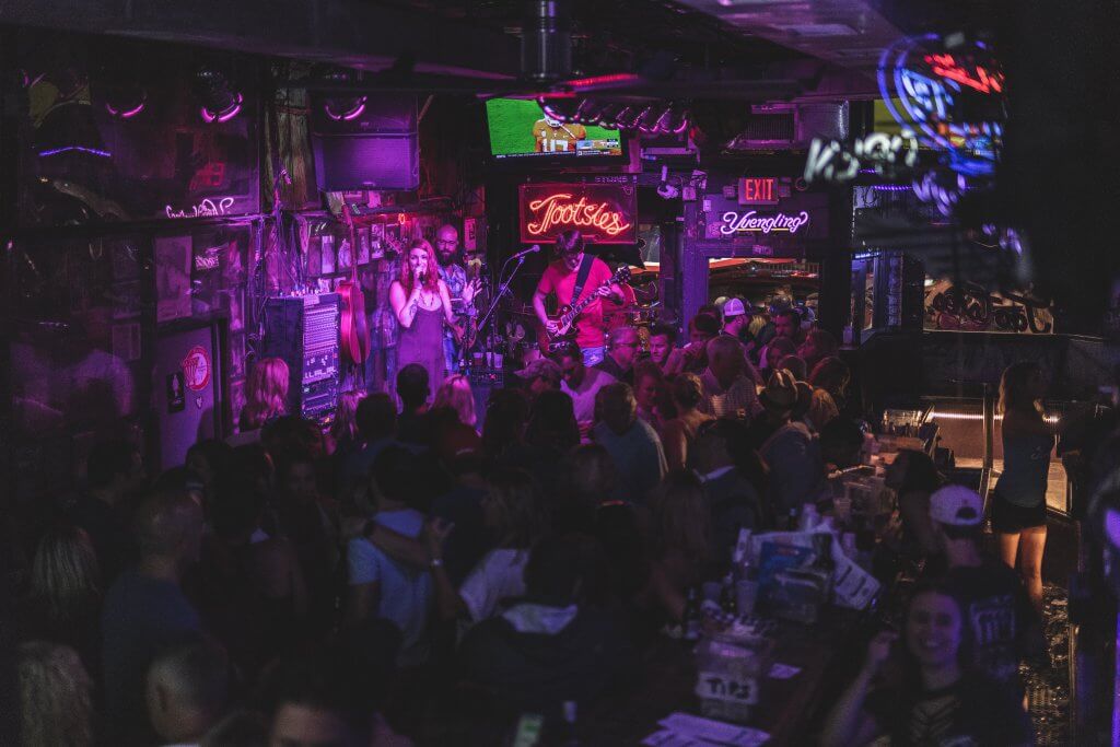 band plays in a dark neon lit room at Tootsie's Orchid Lounge